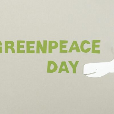 Minimalist paper cutout design for Greenpeace Day with whale illustration on copy space background.